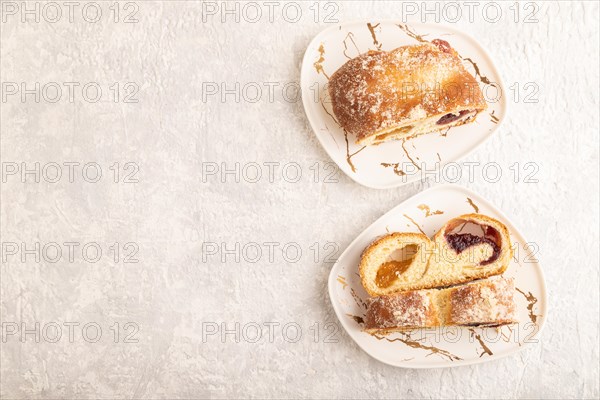Homemade sweet bun with apricot jam on gray concrete background. top view, flat lay, copy space