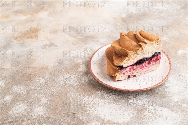 Zephyr or marshmallow cake with cup of coffee on brown concrete background. Side view, copy space