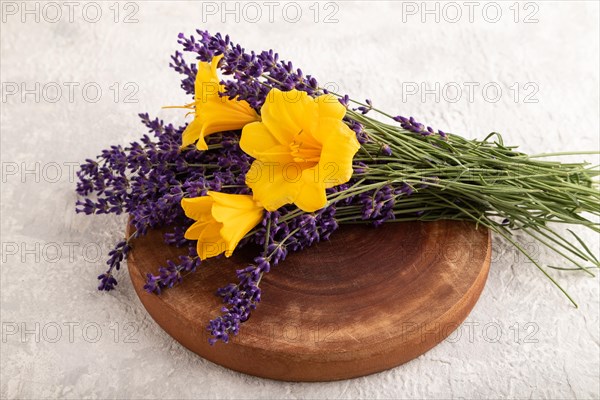 Beautiful day lily and lavender flowers on gray concrete background, side view, close up