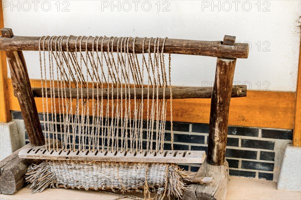 Old fashioned Korean hand loom used to make traditional straw beds in ancient Korea