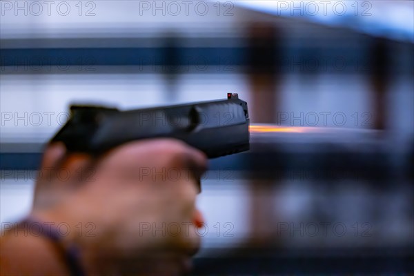 Modern Elegant Handgun in Motion with Fire on Creative Background in Switzerland