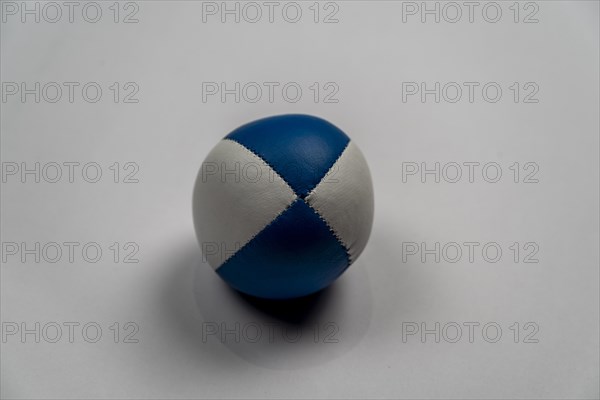 Juggling ball in front of a white background, studio shot, Germany, Europe