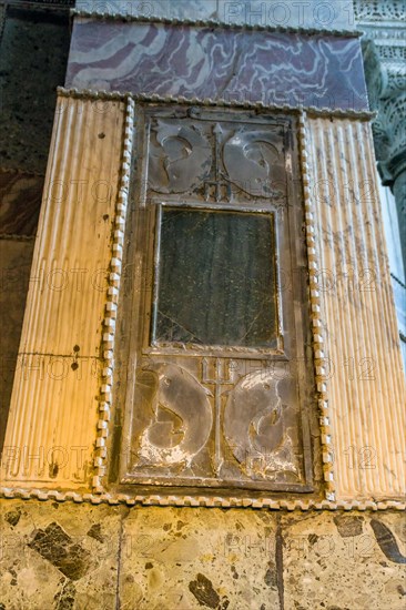 Plaque of Poseidon trident and dolphins on column wall inside Hagia Sophia Mosque in Istanbul, Turkiye