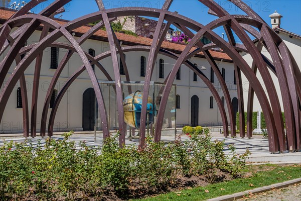 Earth sphere made in early 19th century under arched structure in front of museum in Istanbul, Tuerkiye