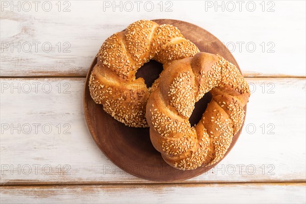 Homemade sweet bun on a white wooden background. top view, flat lay, close up