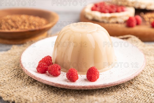 Buckwheat milk jelly on gray wooden background and linen textile. side view, close up, selective focus