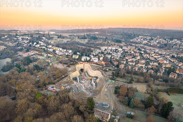 View from above of a tunnel construction site in a residential area at dusk, Pforzheim, Germany, Europe