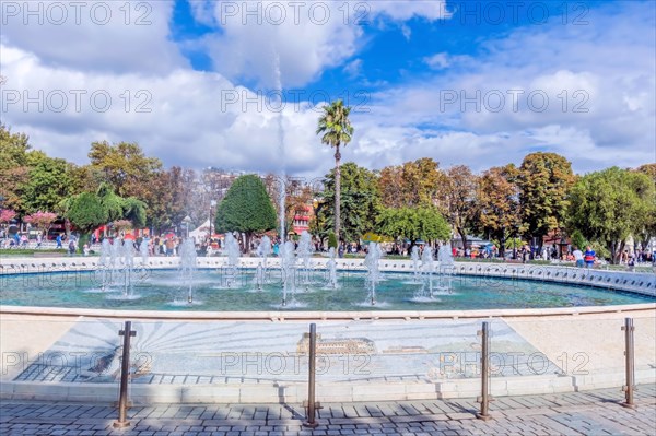 Landscape of fountain in Sultanahmet plaza under cloudy sky in Istanbul, Turkiye