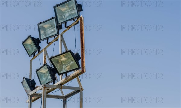 Closeup of flood lights mounted on metal frame against blue sky in Istanbul, Tuerkiye