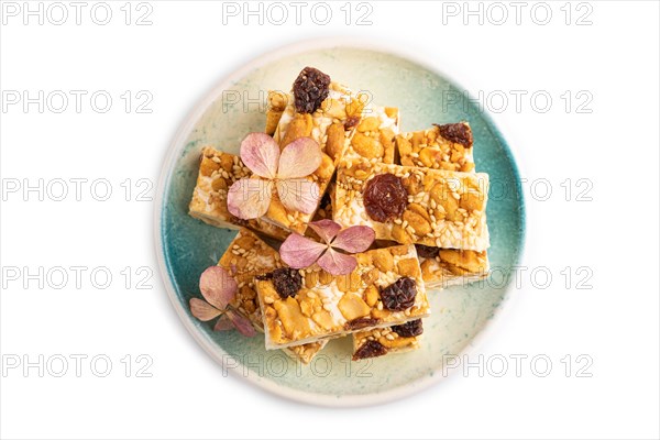 Traditional candy nougat with nuts and sesame isolated on white background. top view, flat lay, close up