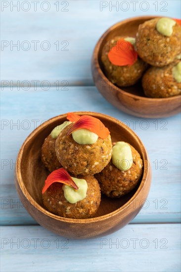 Falafel with guacamole on blue wooden background. Side view, close up