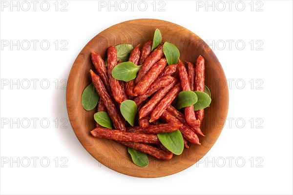 Small smoked sausage with borage microgreen isolated on white background. Top view, flat lay, close up