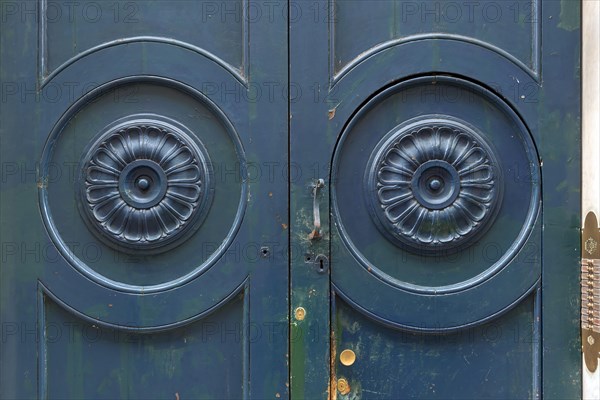 Wooden rosettes on an entrance door in the historic centre, Genoa, Italy, Europe
