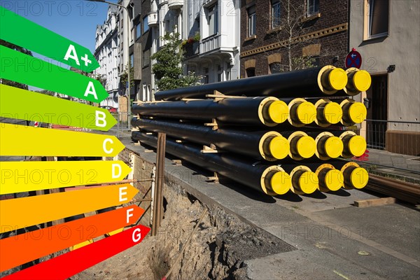 A stack of new pipes for district heating at a construction site, graphic with energy efficiency classes for buildings according to the GEG, Duesseldorf, Germany, energy efficiency, Europe