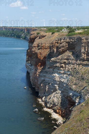 Erosion cliff with visible layers next to clear blue sea, Cape Kaliakra, Dobruja, Black Sea, Bulgaria, Europe