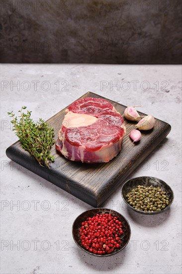 Big piece of raw beef shank cross-cut with spice and herbs