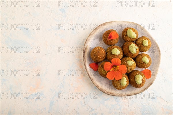 Falafel with guacamole on white concrete background. Top view, flat lay, copy space