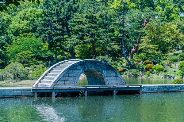 Concrete bridge across lake at Shukkeien Gardens in Hiroshima, Japan, Asia