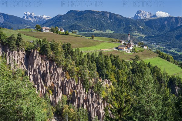Earth pyramids on the Ritten at midday, Geislerspitzen and Schlern in the background, South Tyrol, Italy, Europe