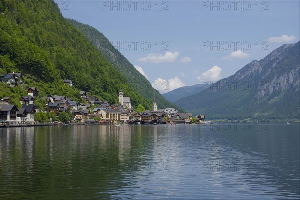 Hallstatt, a charming village on the Hallstattersee lake and a famous tourist attraction, with beautiful mountains surrounding it, in Salzkammergut region, Austria, in summer sunny day, Europe