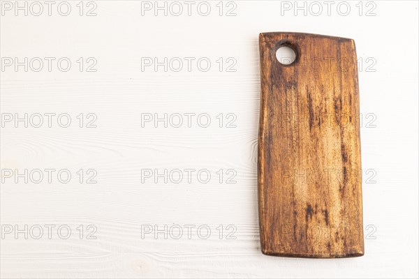 Empty rectangular wooden cutting board on white wooden background. Top view, copy space, flat lay