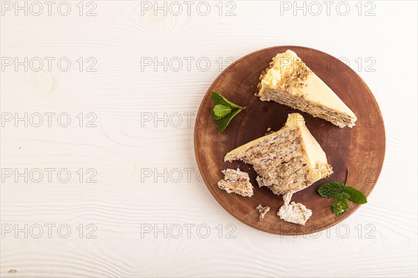 Walnut and almond cake on white wooden background. top view, flat lay, copy space