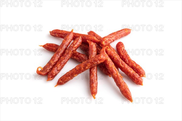 Small smoked sausage isolated on white background. Side view, close up