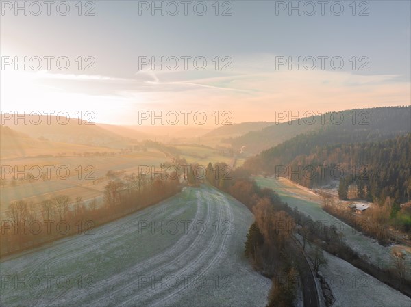 Dawn over a peaceful landscape of fields, forests and misty hills, Nagold, Black Forest, Germany, Europe