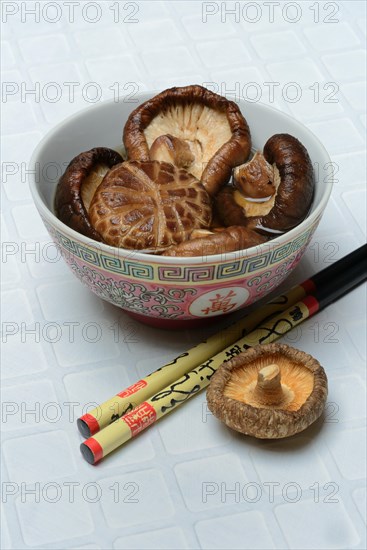 Dried shiitake mushrooms in a bowl, soaked in water