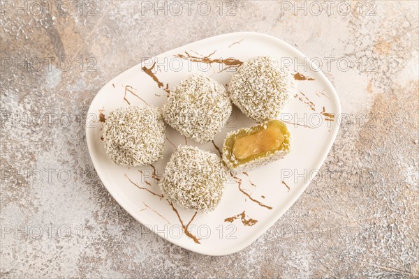 Japanese rice sweet buns mochi filled with pandan jam on brown concrete background. top view, flat lay, close up