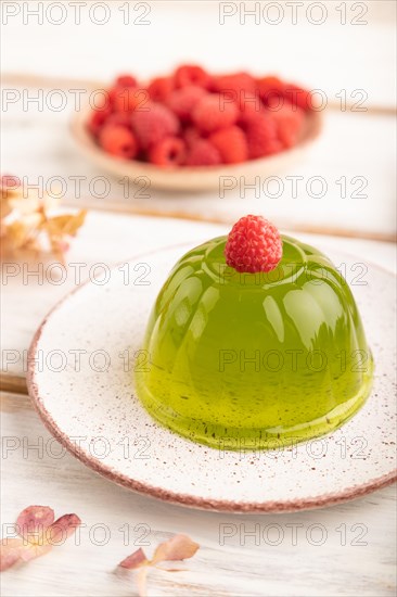 Mint and raspberry green jelly on white wooden background. side view, close up, selective focus