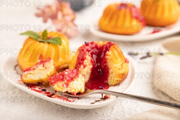 Semolina cheesecake with strawberry jam, lavender, cup of coffee on gray concrete background and linen textile. side view, close up, selective focus