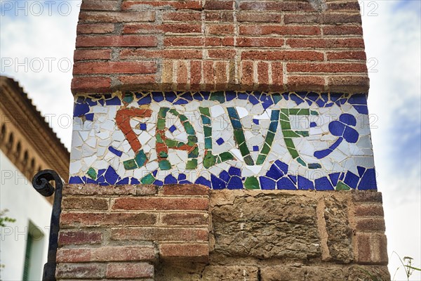 Greeting salute at Casa Trias, tiles with inscription, mosaic, Trencadis, Park Gueell, Barcelona, Spain, Europe