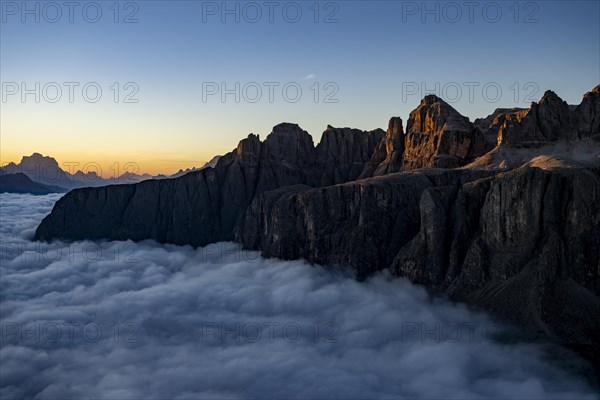 Sunrise over a sea of fog with the peaks of the Sella massif in the background, Corvara, Dolomites, Italy, Europe