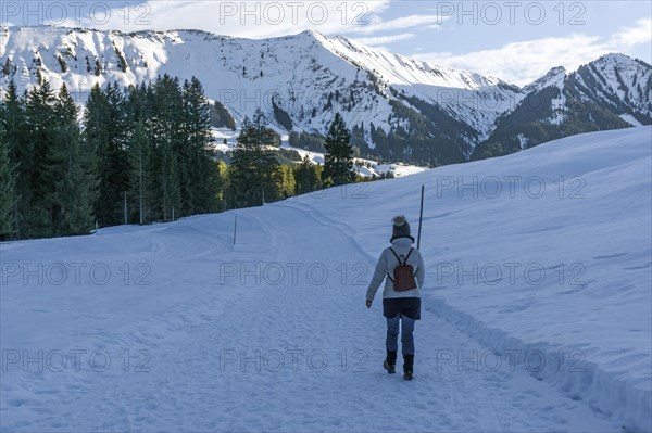 Hiker in the snow, snow hiking, near Riezlern, behind Fellhorn, Kleinwalsertal, Vorarlberg, Austria, Europe