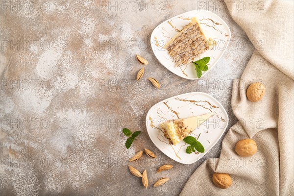 Walnut and almond cake on brown concrete background and linen textile. top view, flat lay, copy space