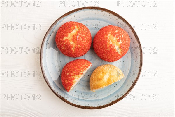 Traditional french custard dessert shu cake on white wooden background. top view, flat lay, close up. Breakfast, morning, concept