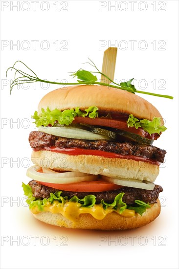 Big double beef burger with fresh vegetables isolated on white