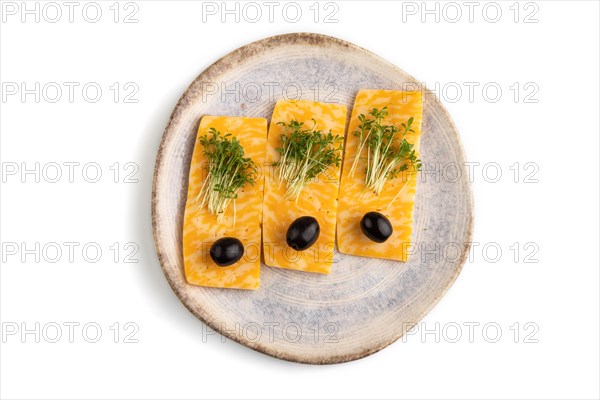 Marble cheese with olives and watercress microgreen isolated on white background. top view, flat lay, close up