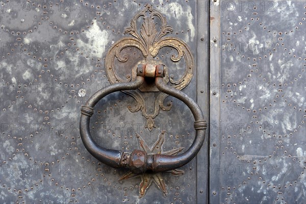 Door knocker on an old metal gate in the historic centre, Genoa, Italy, Europe