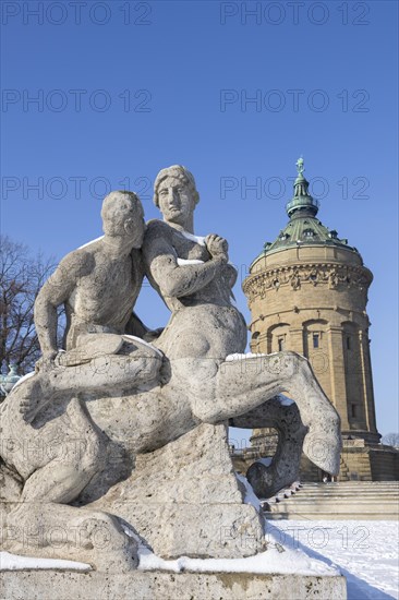 Snow-covered sandstone figures from Greek mythology in front of the historic water tower in Mannheim, Baden-Wuerttemberg, Germany, Europe