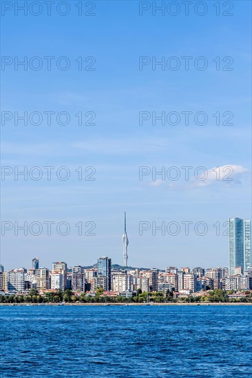Coastal landscape of city buildings with communication tower in background in Turkey