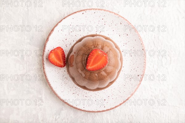 Chocolate jelly with strawberry on gray concrete background. top view, flat lay, close up