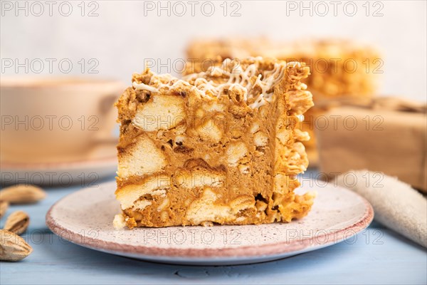 Traditional lithuanian cake shakotis with cup of coffee on blue wooden background and linen textile. side view, close up, selective focus