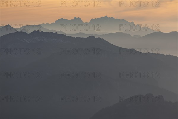 Silhouette of a mountain peak in the evening light, haze, backlight, autumn, view from the Nebelhorn to Hoher Ifen and Saentis, Allgaeu Alps, Allgaeu, Germany, Europe