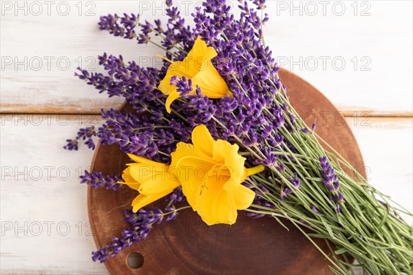 Beautiful day lily and lavender flowers on white wooden background, flat lay, top view, close up