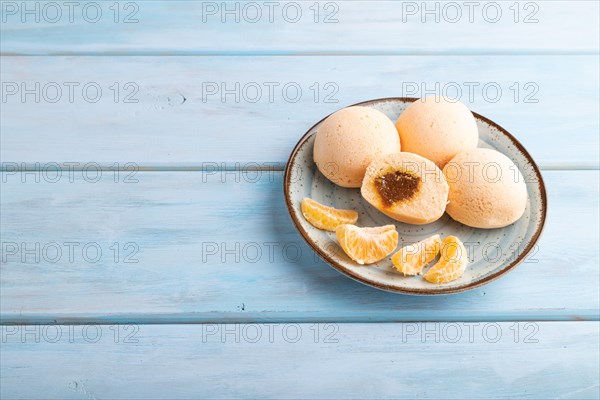 Japanese rice sweet buns mochi filled with tangerine jam on a blue wooden background. side view, copy space