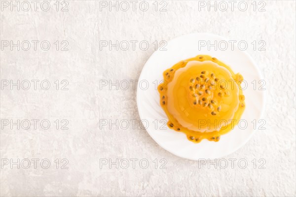 Mango and passion fruit jelly on gray concrete background. top view, flat lay, copy space