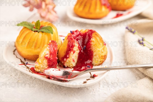 Semolina cheesecake with strawberry jam, lavender, cup of coffee on gray concrete background and linen textile. side view, close up, selective focus