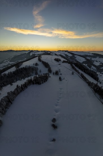 Sunset over the second Jura chain in winter, foreground contours of sinkholes, view towards the first Jura chain with Weissenstein, drone image, Brunnersberg, Solothurn, Switzerland, Europe